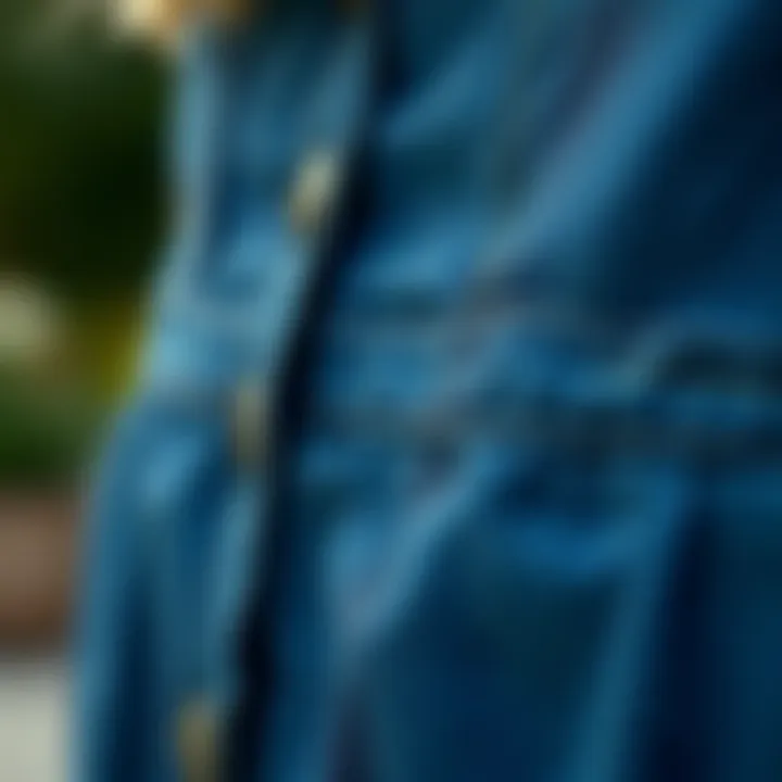 Detail view of the design elements of a plus size denim pinafore, highlighting stitching and fabric texture