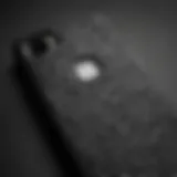 A close-up view of a matte black leopard phone case displaying intricate patterns