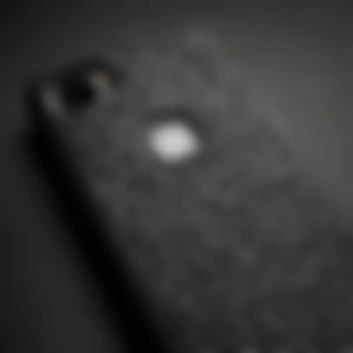 A close-up view of a matte black leopard phone case displaying intricate patterns