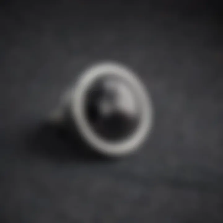 Close-up view of a stylish magnetic stud accessory on a textured fabric background