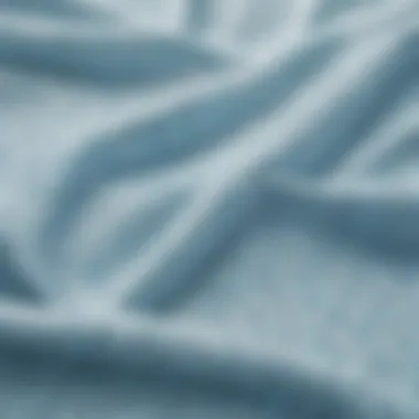 Textural Beauty: Fabric Selection in Swimwear Close-up of fabric texture showcasing the gentle hue of pale blue