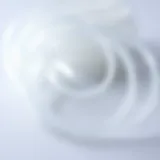 A close-up view of clear elastic string coiled elegantly, showcasing its transparency and flexibility.