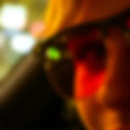 Close-up view of yellow polarized lenses reflecting night lights